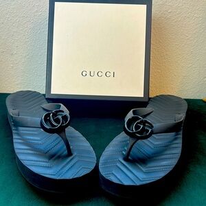 Womens stylish black on black Gucci flip flops.